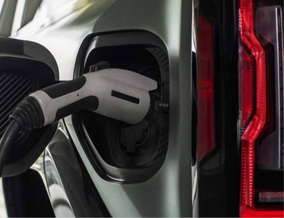 Close up of charging port with charger plugged in on a GMC Hummer EV SUV - Harry's On The Hill in Asheville NC